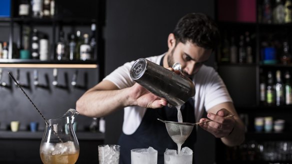 PS40's bartender Michael Chiem prepping drinks made from the in-house sodas.