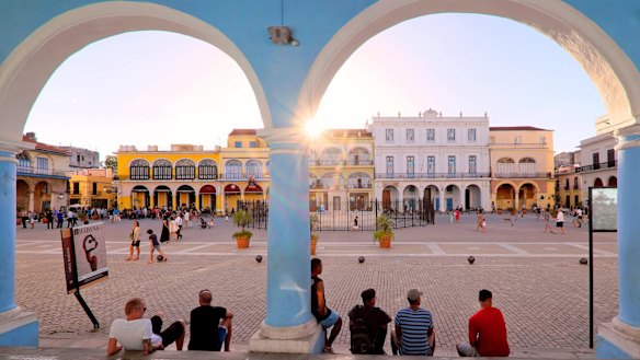 Sun setting over the colourful colonial buildings on Plaza Vieja / Old Square, Havana.