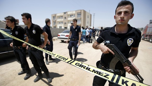 Security outside a building after two police officers were found shot dead in their home in Ceylanpinar, a town near Turkey's border with Syria, on Wednesday.