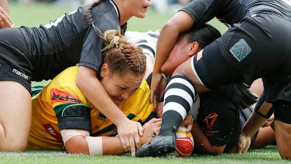 Tangle: Elianna Walton crosses the stripe for the Jillaroos at Suncorp Stadium.
