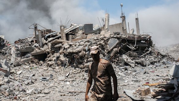 An Iraqi Army soldier walks past a destroyed building in al-Shifa, the last district of west Mosul under Islamic State control.  