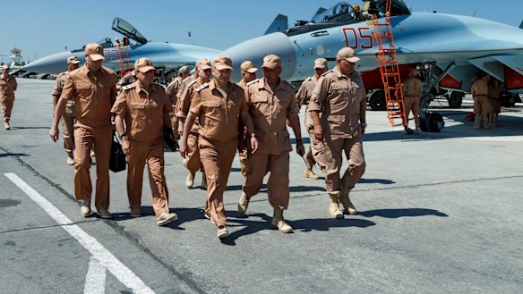 Russian Defence Minister Sergei Shoigu, centre, visits Syria's Hmeimim air base last year.  