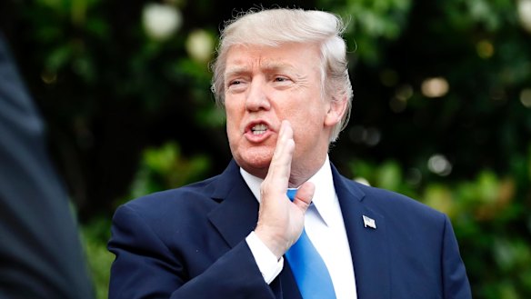US President Donald Trump answers a question as he walks to Marine One, the presidential helicopter, on Wednesday.