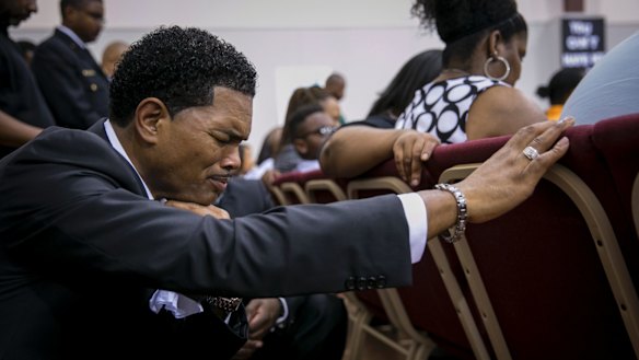 Mourners during a prayer at the funeral of Terence Crutcher.