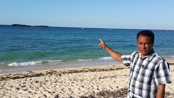 Semuel Messak, the head of Landu village, indicating where the boat came ashore. 