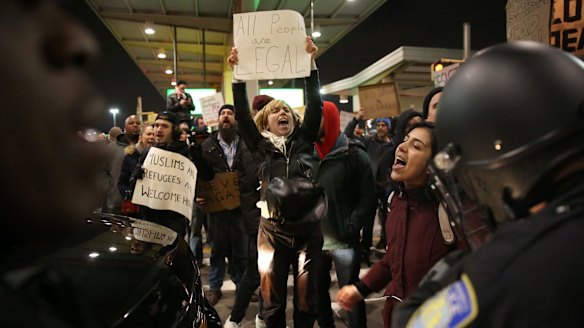Police intervene and arrest some activists during the protest against President Donald Trump's 90-days ban at JFK airport in New York.