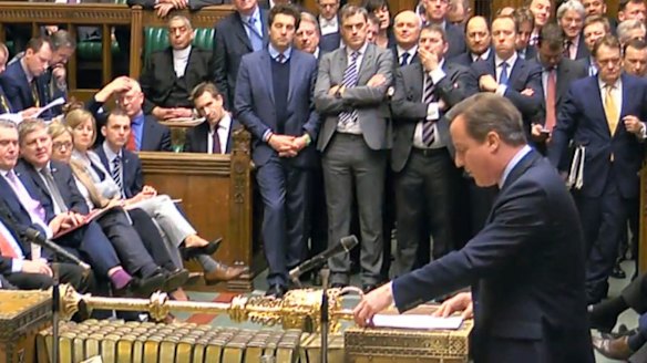 British Prime Minister David Cameron addresses Members of Parliament  in the House of Commons in London on Monday.