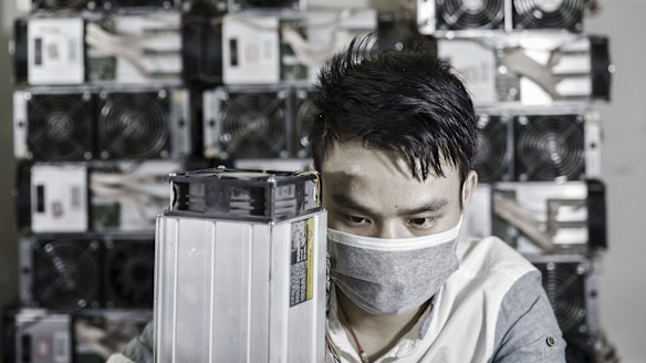 A technician makes repairs to bitcoin mining machines at a mining facilityin China.