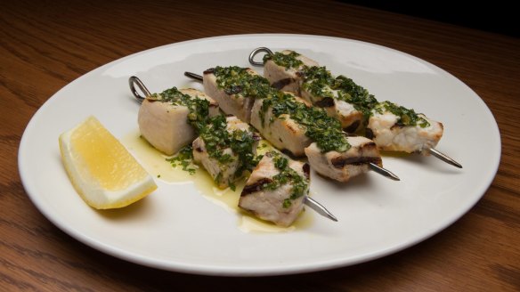 Char-grilled swordfish skewers.