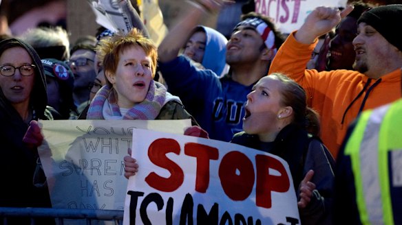 People protesting against Donald Trump shout at Trump supporters in Bethpage, New York.