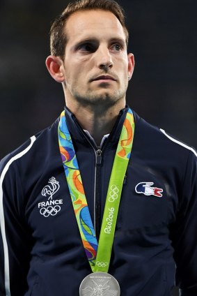 Pole vault silver medallist Renaud Lavillenie of France reacts to booing from the Brazilian crowd during the medal ceremony.