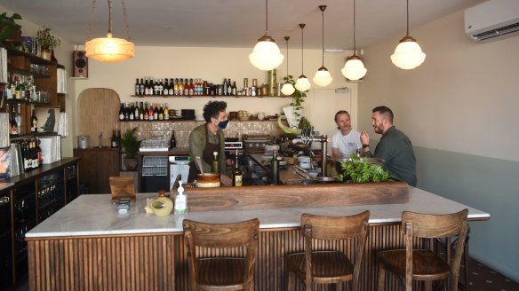 All dishes are prepared behind the marble-topped timber bar.