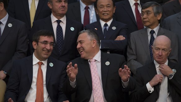 Happy news: Treasurer Joe Hockey (bottom centre) shares a joke with Turkey Deputy Prime Minister Cevdet Yilmaz (left) at the Ankara G20 summit. RBA governor Glenn Stevens (right) has a few things to ponder. 