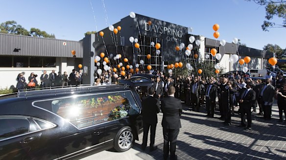Balloons are released at the end of Myuran Sukumaran's funeral.