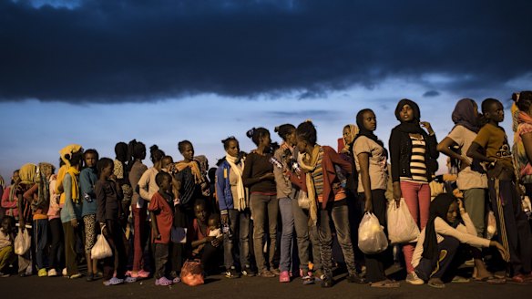 Fleeing multitudes: Hundreds of migrants from sub-Saharan Africa arrive at Augusta port in Sicily in September. 