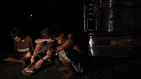 Three men arrested at the scene where three men were killed in a drug related killing in Caloocan, Manila, Philippines. 