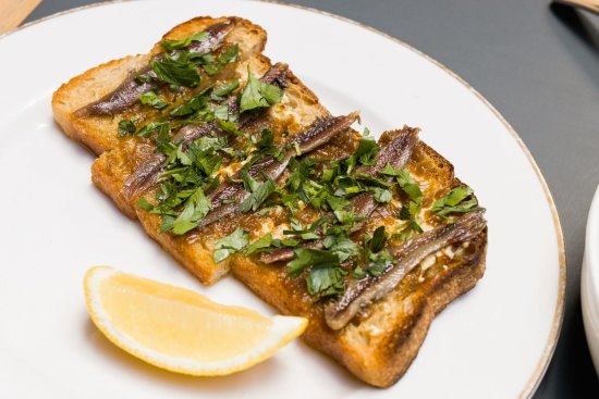 Anchovy, confit shallot and parsley on toast.