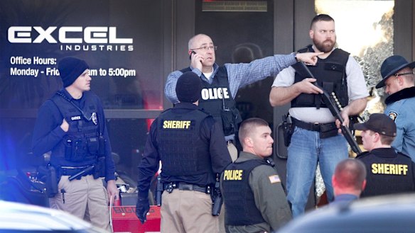 Police guard the front door of Excel Industries in Hesston after the shooting. 