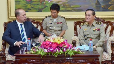 Peter Dutton (left) and Sok Phal (right) meet in Phnom Penh last month.