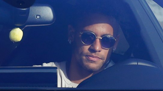 Sad goodbye: Neymar in his car outside Barcelona's training grounds on Wednesday.