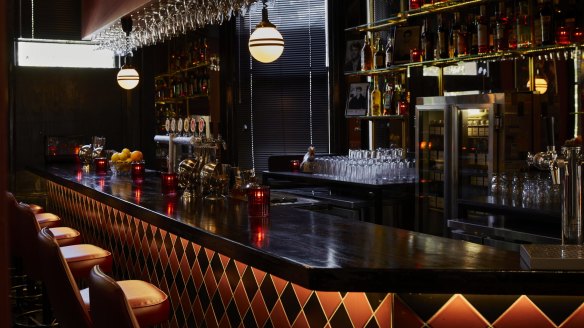 A tiled chequerboard bar is part of the venue's jaunty atmosphere, enhanced by mirror balls, a jukebox and a fish tank.