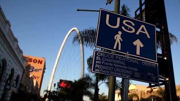 A sign directs pedestrians to the US border crossing in Tijuana, Baja California.