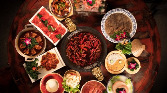 The signature hot pot surrounded by premium cuts of meat and offal for dipping. 
