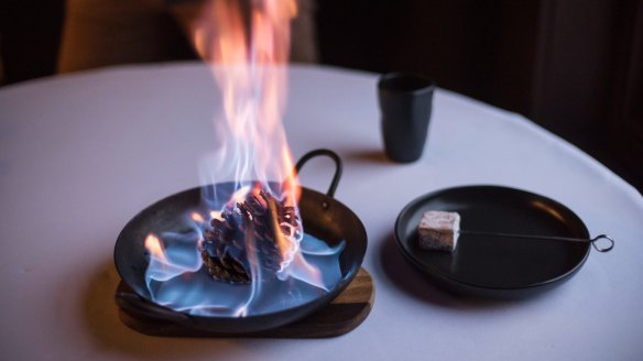 Marshmellow is cooked over a flame at Highline Restaurant.