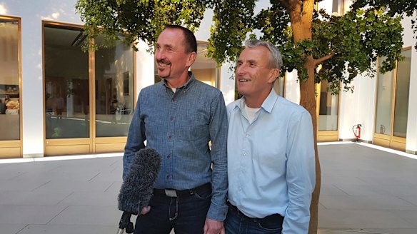 Karl Kreile, left, and Bodo Mende, pose for journalists in Berlin, Germany. 