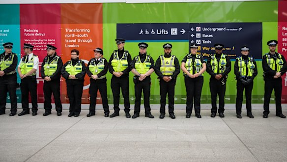 Police officers line up at London Bridge station on Tuesday to observe a minute's silence for the victims of the June 3 terror attacks.