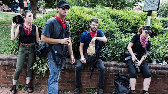 A group of Antifa activists rest during a rally in Charlottesville, Virginia. 
