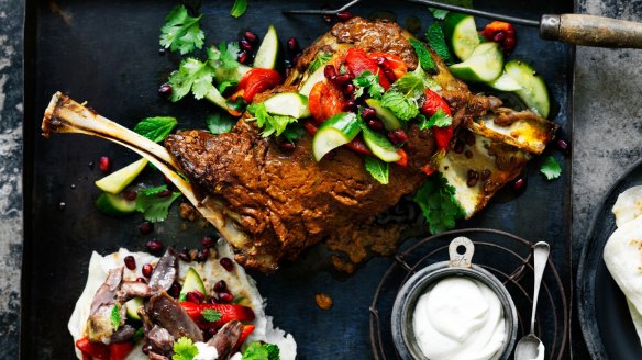 Neil Perry's slow-cooked lamb shoulder with tahini yoghurt, pickled cucumbers, pomegranate and herbs.