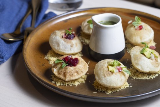 Golgappa filled with potato and green chilli and served with tamarind dressing.