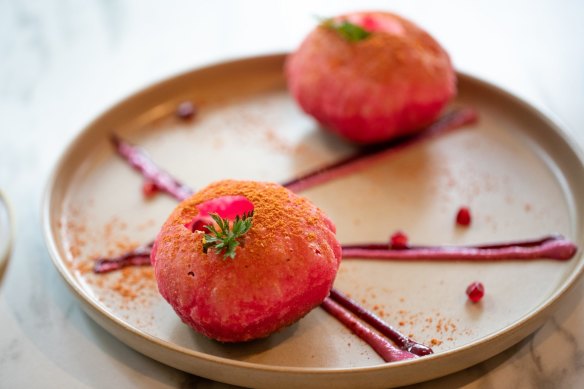 Raj khachori has been reinterpreted as pink semolina domes filled with chickpeas, yoghurt, pomegranate, tamarind and mint chutney.