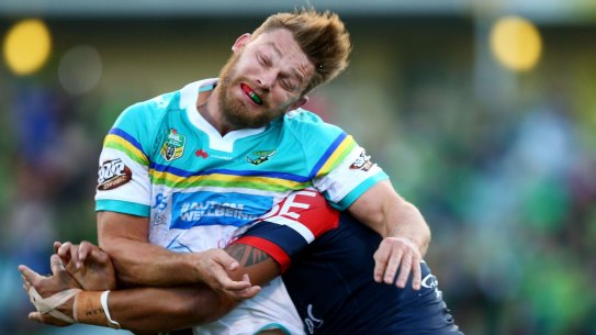 Elliot Whitehead of the Raiders is tackled after offloading.