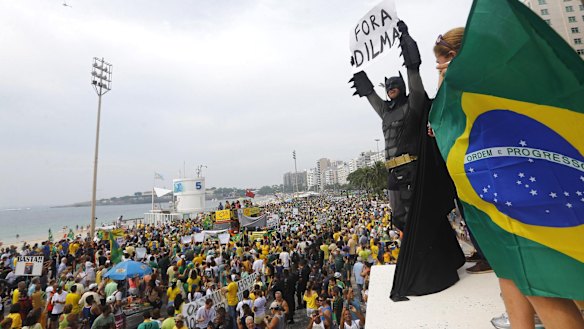 An anti-government demonstrator dressed as Batman holds a placard reading "Out Dilma" during a protest against Brazil's President Dilma Rousseff on Copacabana beach in Rio de Janeiro earlier this month.