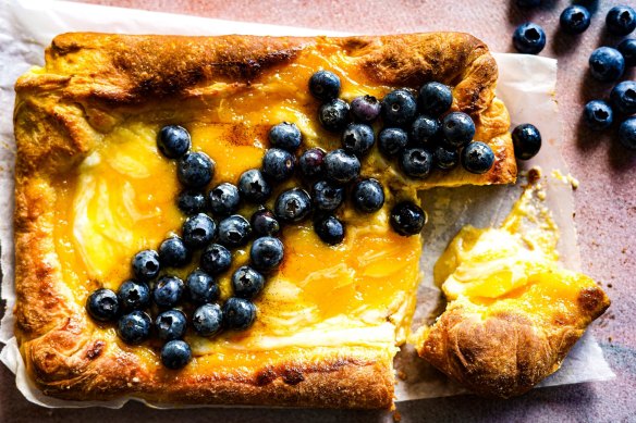 A fluffy, buttery pillow slathered with lemon curd and ricotta and scattered with berries.