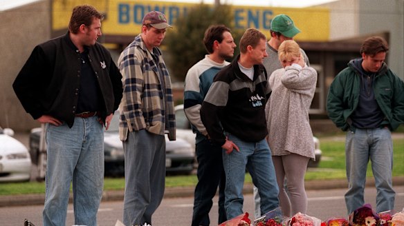 Mourners lay flowers at the scene on August 17, 1998.