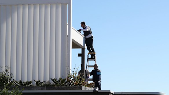 Police search the gutters of John Ibrahim's Dover Heights home.
