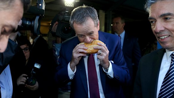 The controversial moment as Bill Shorten bites into a sausage sizzle...from the side.