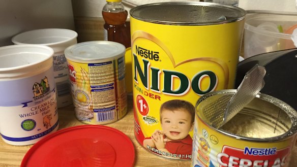 Open tins of baby formula were littered around the kitchen.