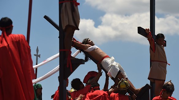 Reuben Enaje re-enacts Christ's crucifixion in Barangay San Pedro Cutud in Pampanga, north of Manila
