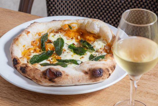 Pizza with pumpkin, stracciatella, pine nuts and fried sage.