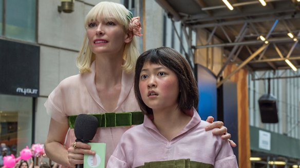 Tilda Swinton as Lucy Mirando (left) and Ahn Seo-Hyun as Mija in Okja.