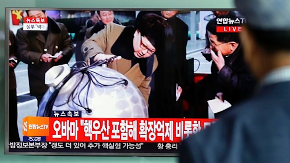 A South Korean man watches a TV news program showing North Korean leader Kim Jong-un inspecting military installations.