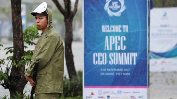 A security guard stands in the rain outside the Ariyana Danang Exhibititon & Convention Centre in Danang, Vietnam.