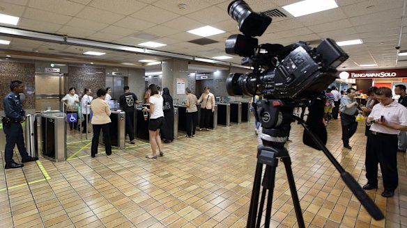 Members of the media await news of Lee Kuan Yew's health at the Singapore General Hospital on Wednesday. 
