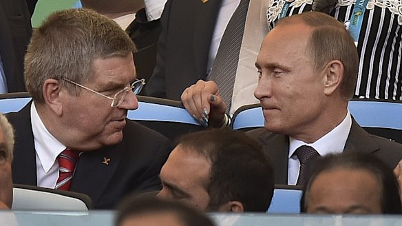 At odds: IOC President Thomas Bach with Russian President Vladimir Putin before the World Cup final in Rio in July.