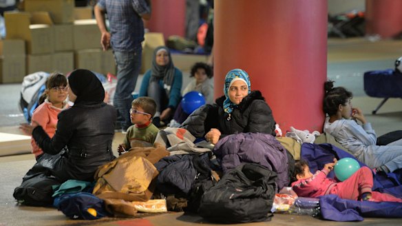Refugees rest in a parking garage in the main rail station in Salzburg, Austria,  in September 2015.