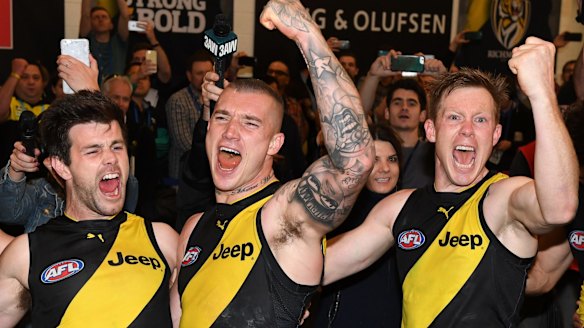 Richmond players Trent Cotchin, Dustin Martin and Jack Riewoldt celebrate their win on Saturday.